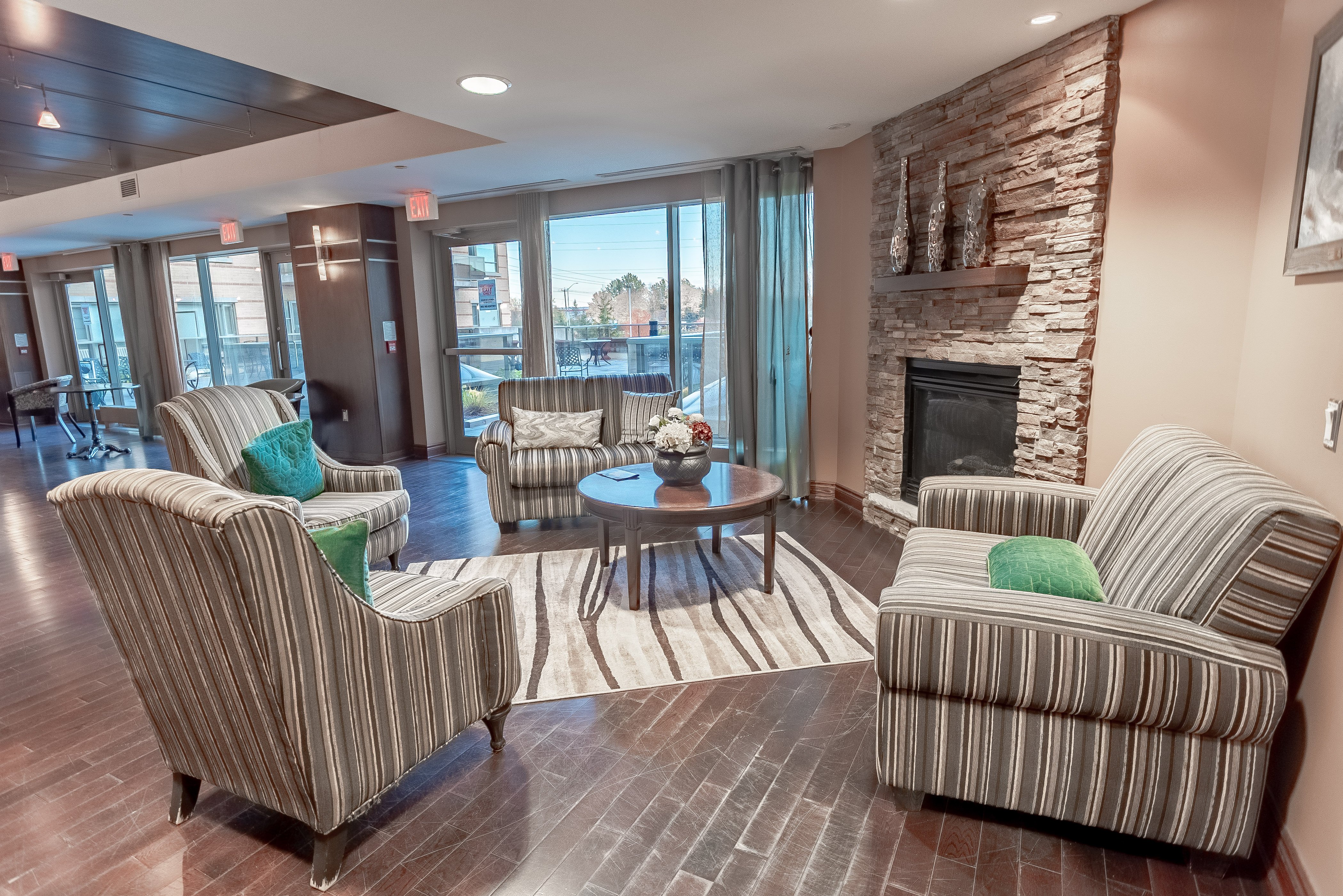 Seating area around the fireplace at Royale Place Retirement Residence